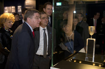 People look at a glass from an ancient era that has become an exhibit